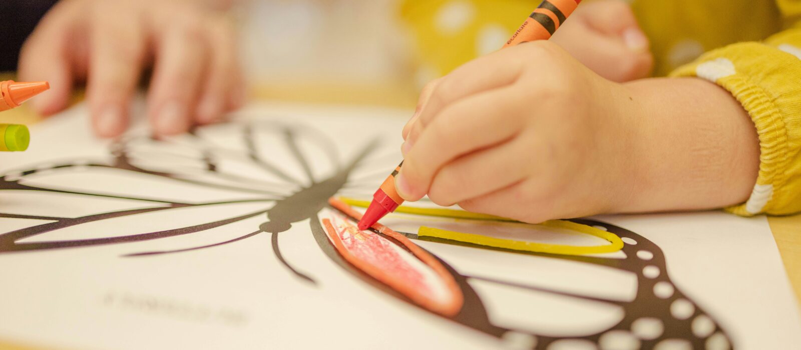 Child drawing with crayons